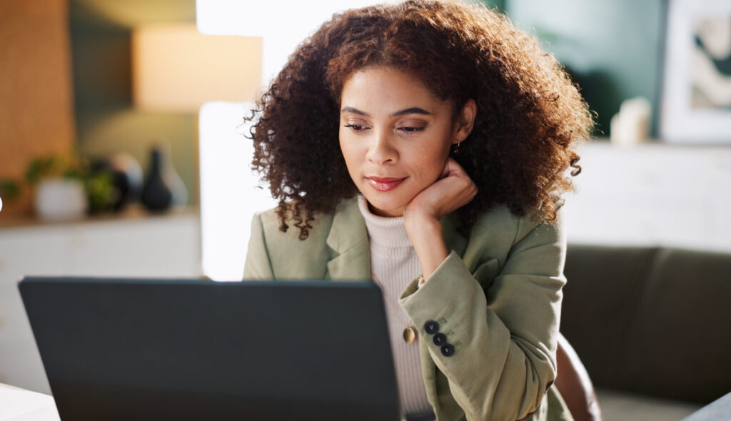 Office, female employee with laptop using mortgage automation technology