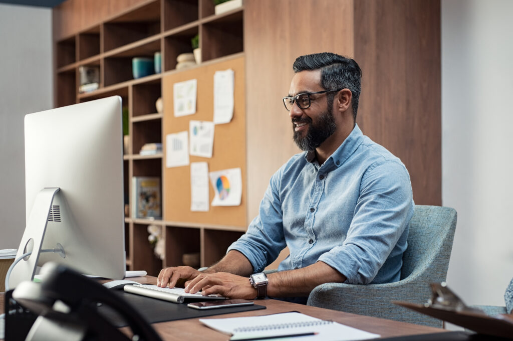Mortgage servicing professional working at a desk on a computer